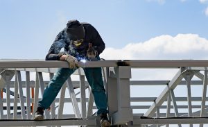 man welds at the factory