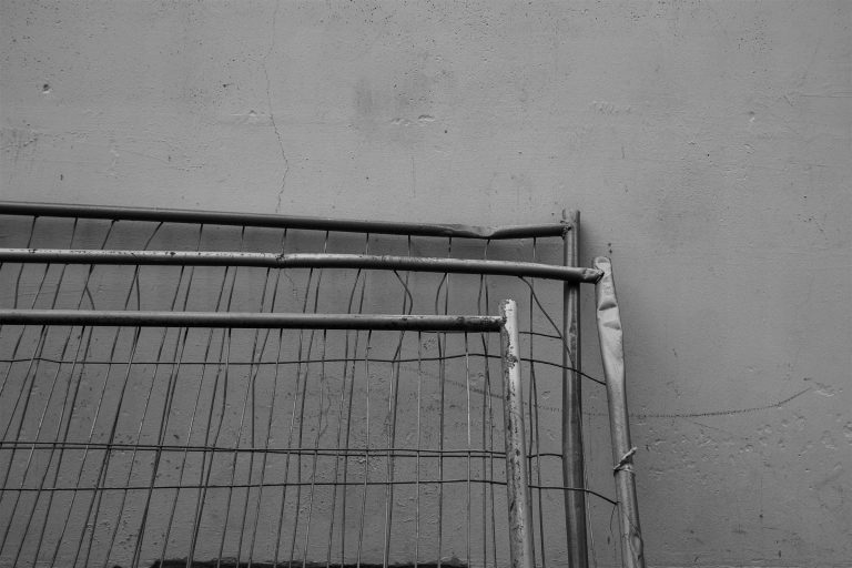 Bent and damaged section of a metal fence