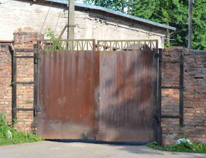 Old rusty iron gate showing wear and damage