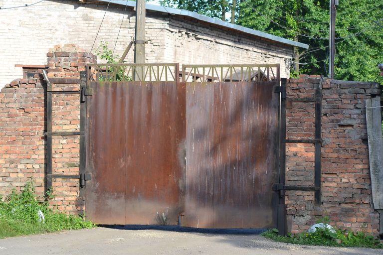 Old rusty iron gate showing wear and damage