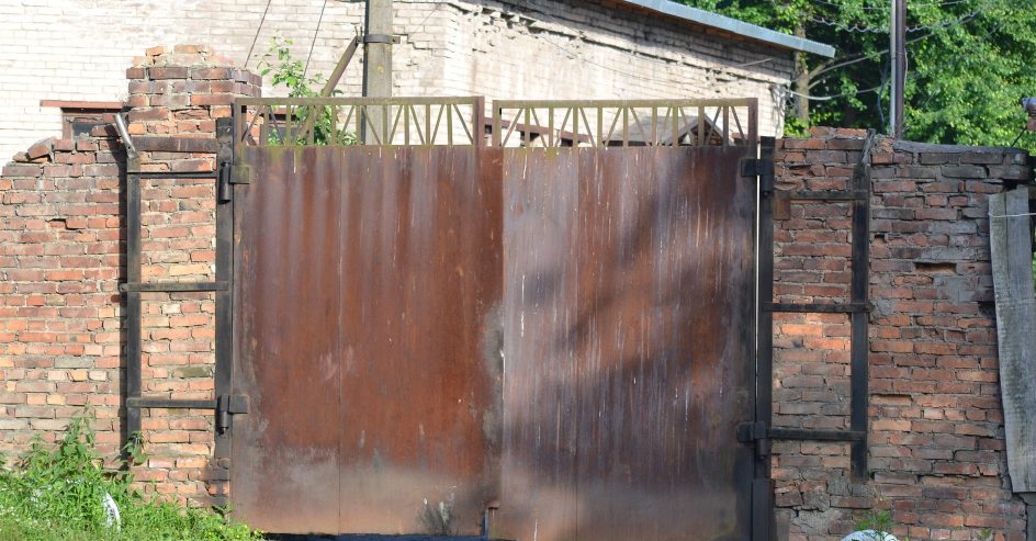Old rusty iron gate showing wear and damage