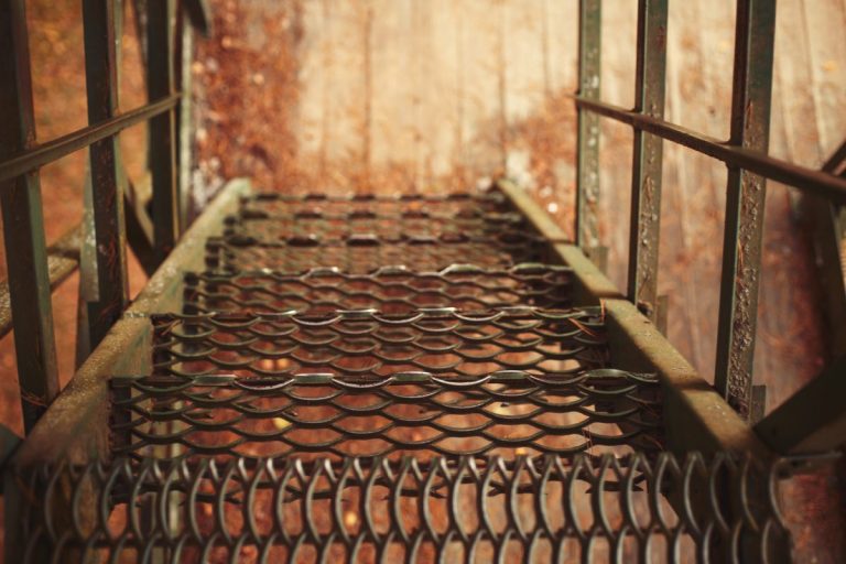 Rusted grated steel stair treads seen from above
